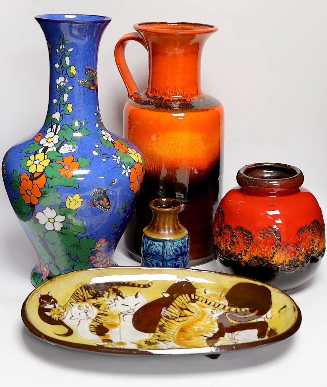 Five mid century pottery pieces including a Joyce Morgan 'cat' tray, an Adderley blue ground vase, and three W. German vases including 'Fat Larva' vase, tallest 42cm